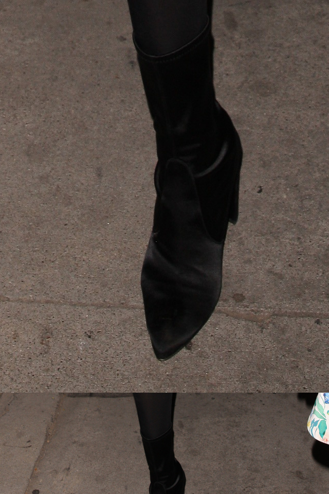 Syn Magica Johnsona w wysokich SZPILKACH przegina się przed restauracją