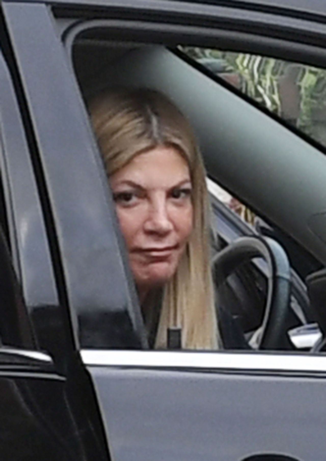 EXCLUSIVE: Tori Spelling cries in her car after learning about Luke Perry's sudden death