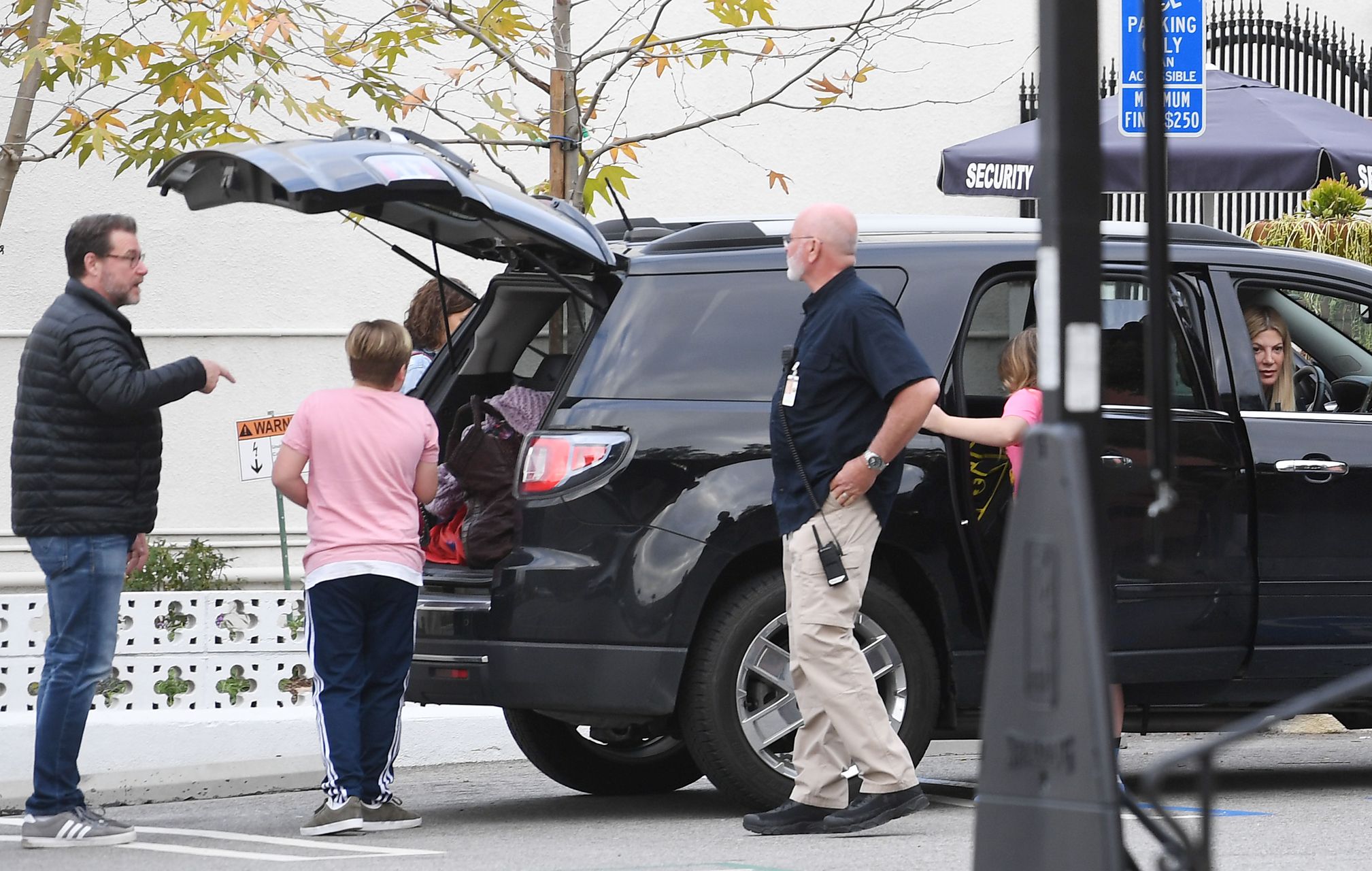 EXCLUSIVE: Tori Spelling cries in her car after learning about Luke Perry's sudden death