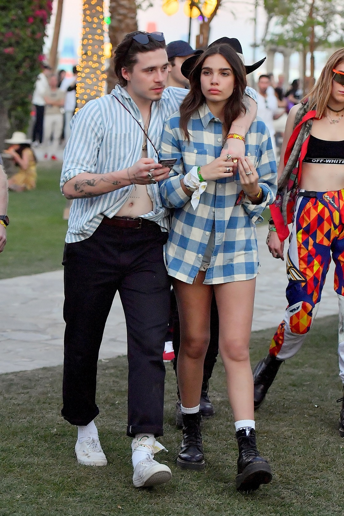EXCLUSIVE: Brooklyn Beckham and his girlfriend Hana Cross chow down on some food at Coachella