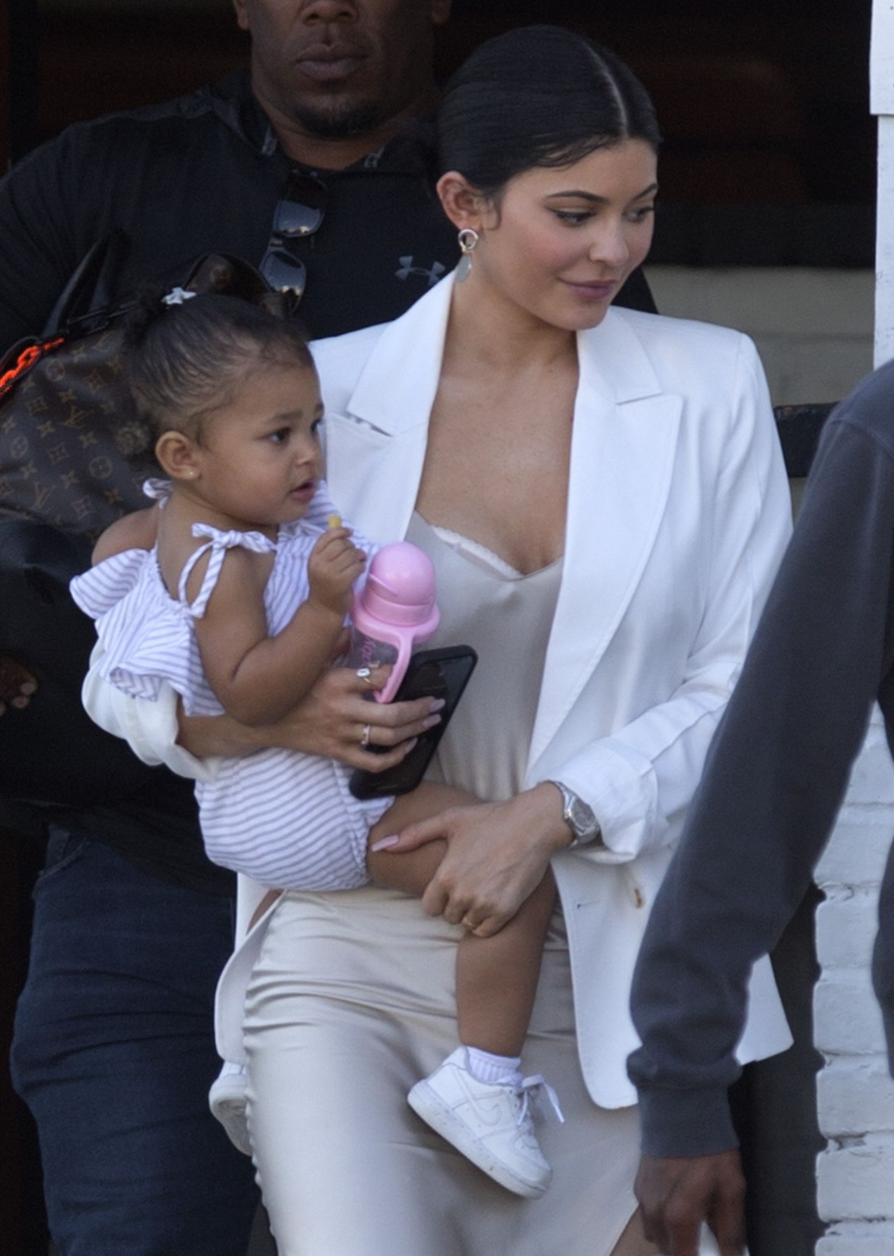 EXCLUSIVE: Kylie Jenner holds baby Stormi in her arms as she and Travis Scott leave a cafe in West Hollywood