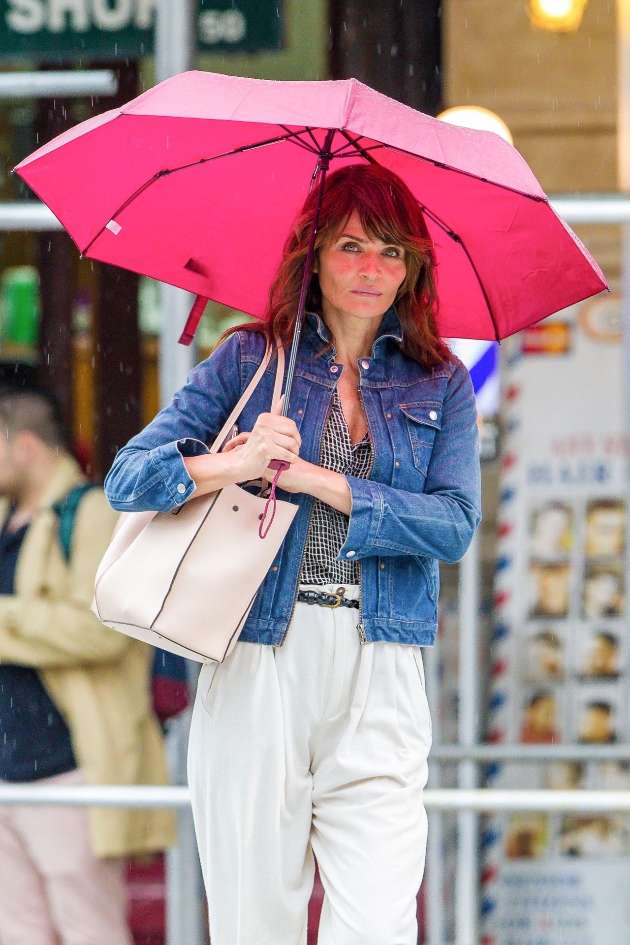 *EXCLUSIVE* Helena Christensen sports a bright pink umbrella on a rainy New York afternoon Helena Christensen