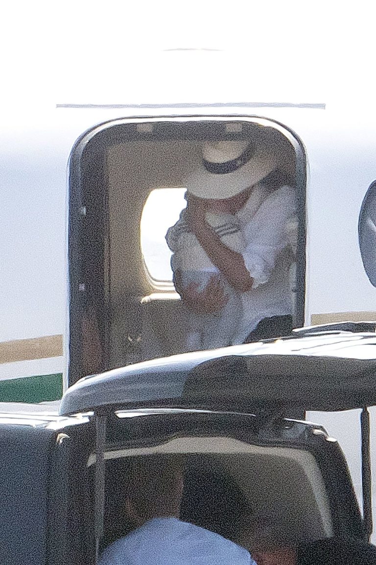 *PREMIUM EXCLUSIVE NO WEB UNTIL 2230 BST 18TH AUG* Meghan Markle cradles baby son Archie in both arms as she leaves the luxury private jet she and Prince Harry have come under fire for using while claiming to be eco warriors.