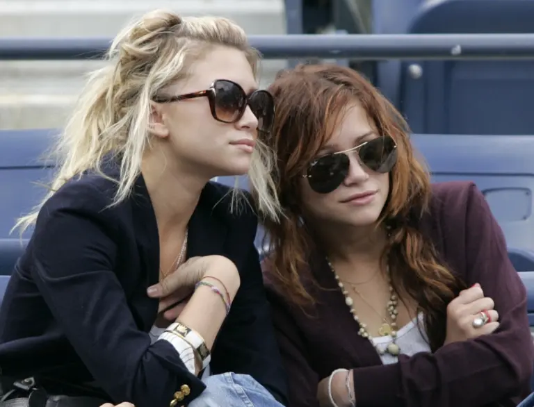 Mary Kate and Ashley Olsen sit at the U.S. Open before men's semifinals. Mary Kate and Ashley Olsen sit at the U.S. Open before men's semifinals.
