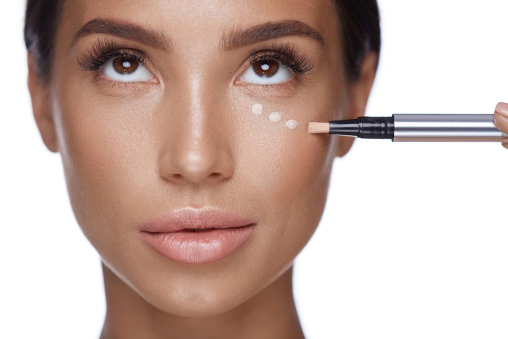 Beauty Woman Face Makeup. Female Applying Corrector Under Eyes Beauty Woman Face Makeup. Female Applying Corrector Under Eyes