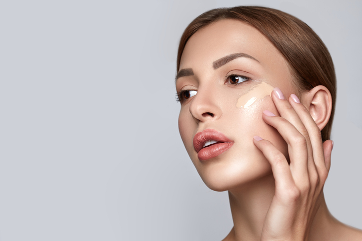 Woman applying foundation. Skin tone cream lines on woman face. Beautiful woman portrait beauty skin healthy and perfect makeup. Space for text.